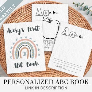 May include: A personalized alphabet book with a rainbow and moon design. The cover says "Avery's First ABC Book".