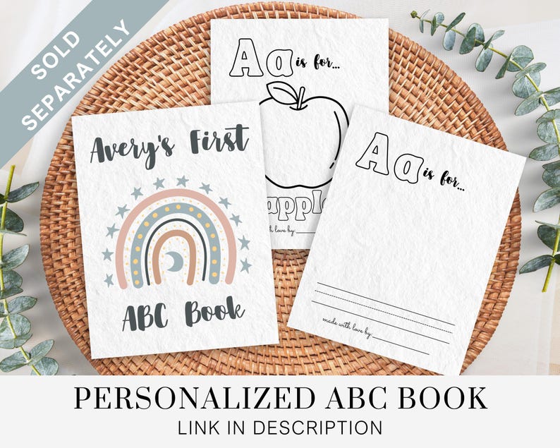 May include: A personalized alphabet book with a rainbow and moon design. The cover says "Avery's First ABC Book".