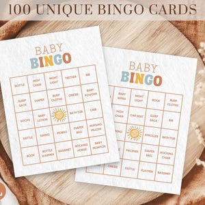 May include: Two printable baby bingo cards with a light blue and orange colour scheme. The cards feature a sun icon and the words "Baby Bingo" in a colourful font. The cards are filled with baby-related words like "bottle", "diaper", "onesie", and "rocking horse".
