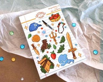 May include: A sheet of stickers with various illustrations, including a baseball cap, a pen, a basket of strawberries, a necklace, a coin, a bird, a trident, a sword, a strawberry, a cloud, and a pan flute. The sheet is on lined paper.