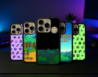 May include: Five phone cases with pixelated designs. The cases feature various colorful designs, including a night sky with a moon, a landscape with mountains, and other game-related graphics. The cases are black with a glossy finish.