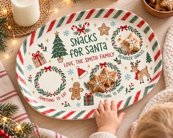 May include: An oval ceramic serving tray with a red and green striped border. The center features the text "SNACKS FOR SANTA" and "LOVE, THE SMITH FAMILY" surrounded by illustrations of a Christmas tree, reindeer, gingerbread man, and wreaths.