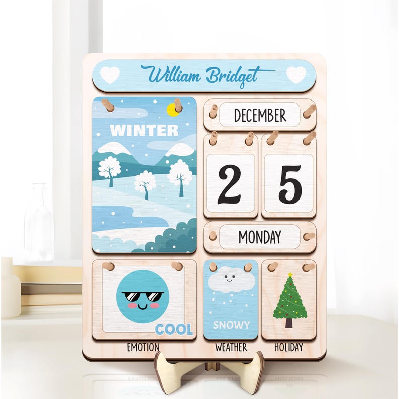 May include: A wooden calendar with a blue and white winter scene, a date of December 25th, and the word "Monday". The calendar also has a cool emoji, a snowy cloud, and a Christmas tree.