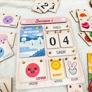May include: A wooden calendar with a pink background and a heart at the top. The calendar says "Sorensen's" and has a date of March 4th, Sunday. The calendar also has a winter scene, a smiley face, a sun, and a bunny rabbit.