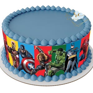 May include: A blue frosted cake with a colorful edible image of superheroes including Iron Man, Captain America, Thor, Hulk, Batman, and Spiderman.