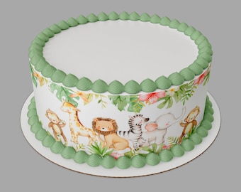 May include: A white cake with green frosting and a jungle animal themed edible image. The image features a giraffe, zebra, elephant, monkey, and lion.