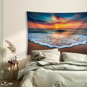 May include: A tapestry featuring a vibrant sunset over a calm ocean with foamy waves crashing on the sandy shore.
