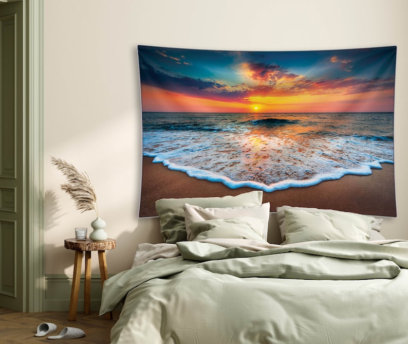 May include: A tapestry featuring a vibrant sunset over a calm ocean with foamy waves crashing on the sandy shore.