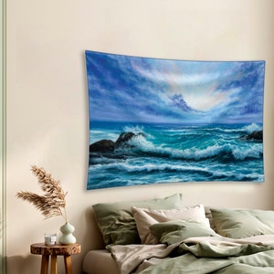 May include: A tapestry featuring a seascape with blue and green waves crashing against rocky shores. The sky is a mix of blue and gray with white clouds. The scene is reminiscent of a stormy day at sea.