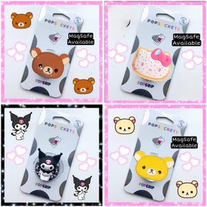 May include: Four different phone grip designs featuring popular cartoon characters. Each design is on a white background with pink hearts and the text "POPSOCKETS" and "POPGRIP". The text "MagSafe Available" is also included on each design.