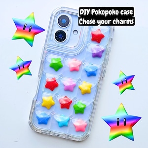 May include: A transparent phone case filled with star-shaped charms in a variety of colours. The case features a grid of star-shaped charms in red, pink, yellow, green, and blue. Text reads "DIY Pokopoko case Chose your charms".