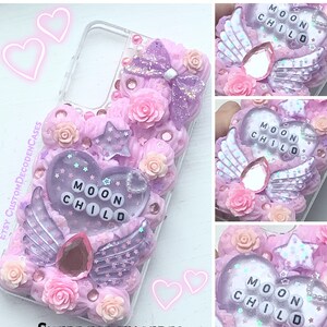 May include: A pink and purple phone case with a heart-shaped design and the words "Moon Child" in white letters. The case is decorated with glitter, stars, and flowers.