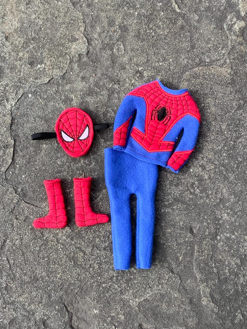 May include: A Spider-Man costume set, featuring a red and blue top, blue pants, red boots, and a red mask with white eye details. The top has a black spider emblem.