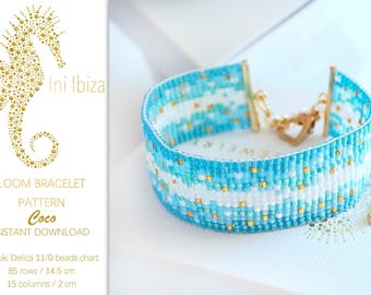 May include: A beaded loom bracelet in shades of blue, white, and gold. The bracelet has a woven pattern with gold accents and a gold clasp. The text "Ini Ibiza" and "Coco" are visible.