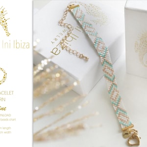 以下が含まれることがあります： 金色のハートのチャームが付いた白とターコイズの織りブレスレット。ブレスレットの長さは14cm、幅は1cmです。ブレスレットはミユキデリカ11/0ビーズで作られています。パターンは「アデリン」と呼ばれています。