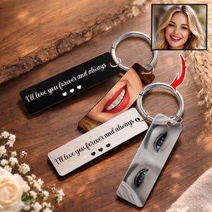 May include: Keychains with personalized images and text. One keychain is black with the text "I'll love you forever and always" and three hearts. Another keychain features a close-up of a smiling mouth. The third keychain has a grayscale image of eyes.