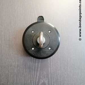 May include: A black ceiling hook with a silver swiveling ring and a toggle switch labelled "ON" and "OFF".