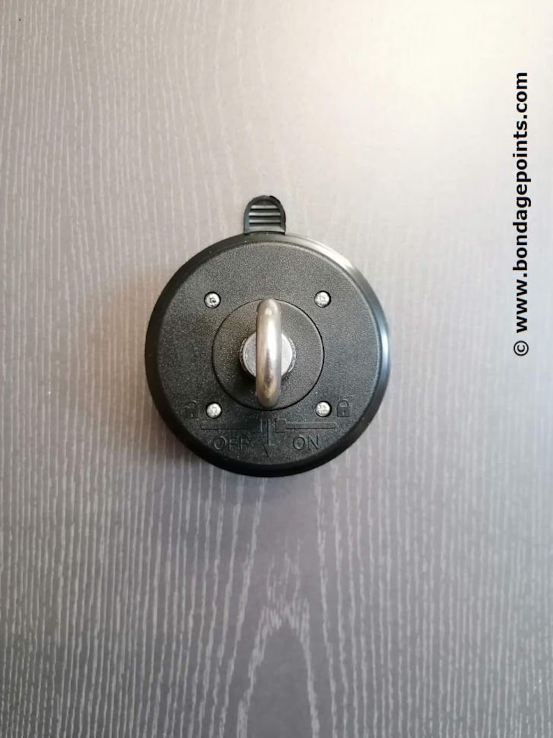 May include: A black ceiling hook with a silver swiveling ring and a toggle switch labelled "ON" and "OFF".