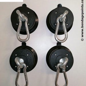 May include: Four black suction cup hooks with silver swiveling carabiners. Made in Germany. www.bondagepoints.com