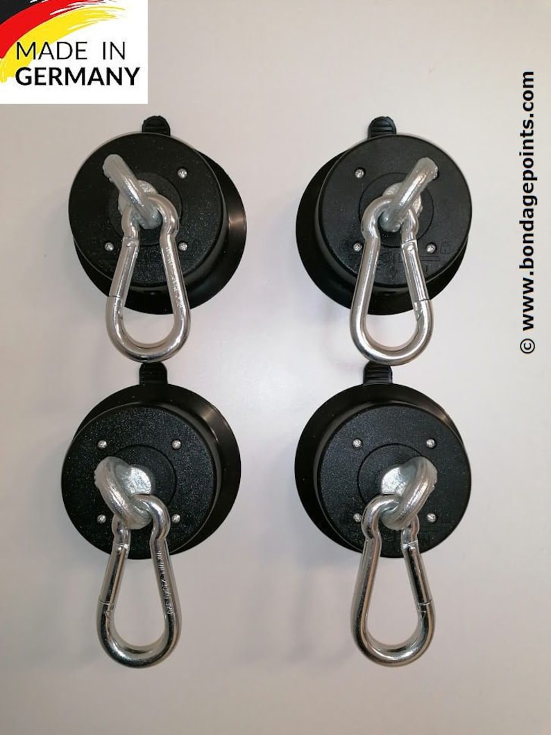 May include: Four black suction cup hooks with silver swiveling carabiners. Made in Germany. www.bondagepoints.com