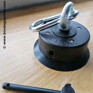 May include: A black suction cup with a silver swivel hook and a lever to lock the hook in place. The suction cup has a small hole for air release. A black plastic rod with a round end is also included.