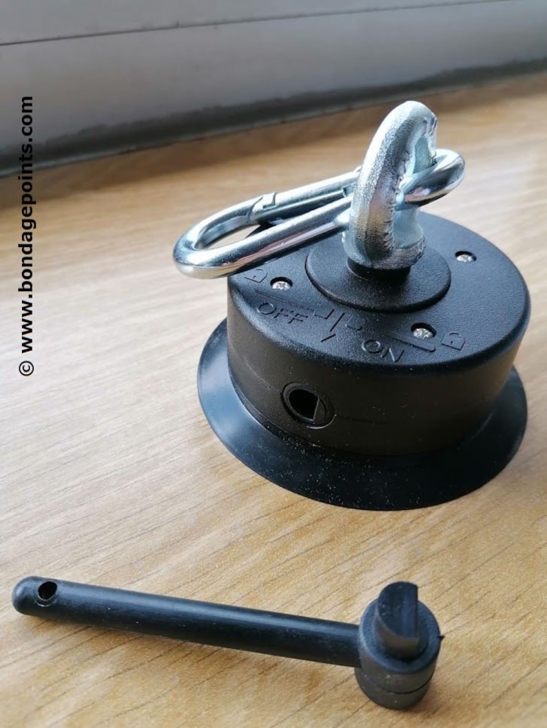 May include: A black suction cup with a silver swivel hook and a lever to lock the hook in place. The suction cup has a small hole for air release. A black plastic rod with a round end is also included.