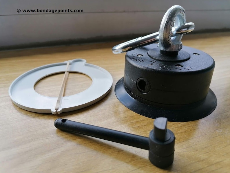 May include: A black suction cup with a silver swivel hook and a rubber ring. A white plastic ring with a rubber band and a black plastic handle are also included.