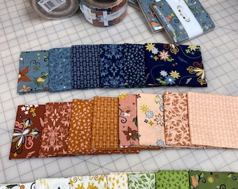 May include: A collection of fabric squares in various patterns and colors, including blue, green, yellow, and orange. The fabric squares are arranged in rows and are ready to be used for quilting or other craft projects.