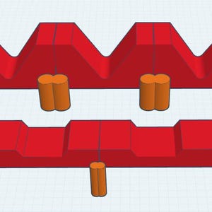 Può includere: Un dima per la lavorazione del legno rossa, stampata in 3D, con una parte superiore a forma di V e una base piatta. Include perni cilindrici e anelli circolari arancioni. Strumento per il taglio o l'assemblaggio preciso di pezzi di legno.