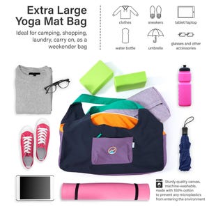 May include: An extra large yoga mat bag with a dark blue exterior, purple front pocket featuring a circular logo, and orange interior lining. The bag is surrounded by a grey sweater, black glasses, red sneakers, a tablet, a pink yoga mat, a pink water bottle, and a navy umbrella.