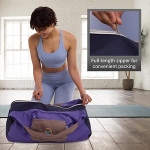 May include: A purple and navy duffel bag with a full-length zipper, shown open with a brown pouch in the front pocket. The bag is on a wooden floor, and the text "Full-length zipper for convenient packing" is visible.