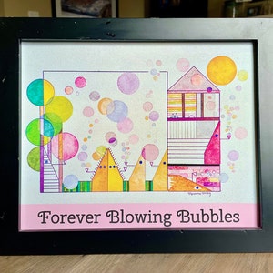 May include: A framed print of a colorful abstract art piece with a house, trees, and bubbles. The title of the artwork is "Forever Blowing Bubbles".