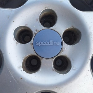 A set of 4 centre caps for VW Corrado VR6 in the style of Speedline