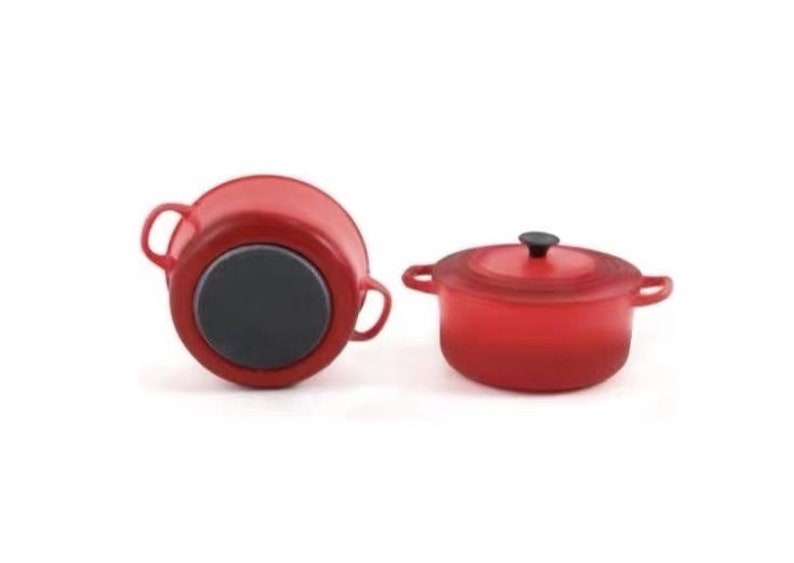 May include: Two red cast iron Dutch ovens with black handles and lids. One oven is shown from the bottom and the other is shown from the side.