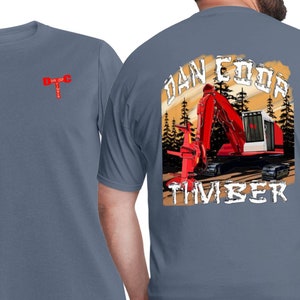 May include: A blue t-shirt with a red and white excavator graphic on the back. The graphic says "Dan Coor Timber". The front of the shirt has a small red and white graphic of a wrench and a hammer.