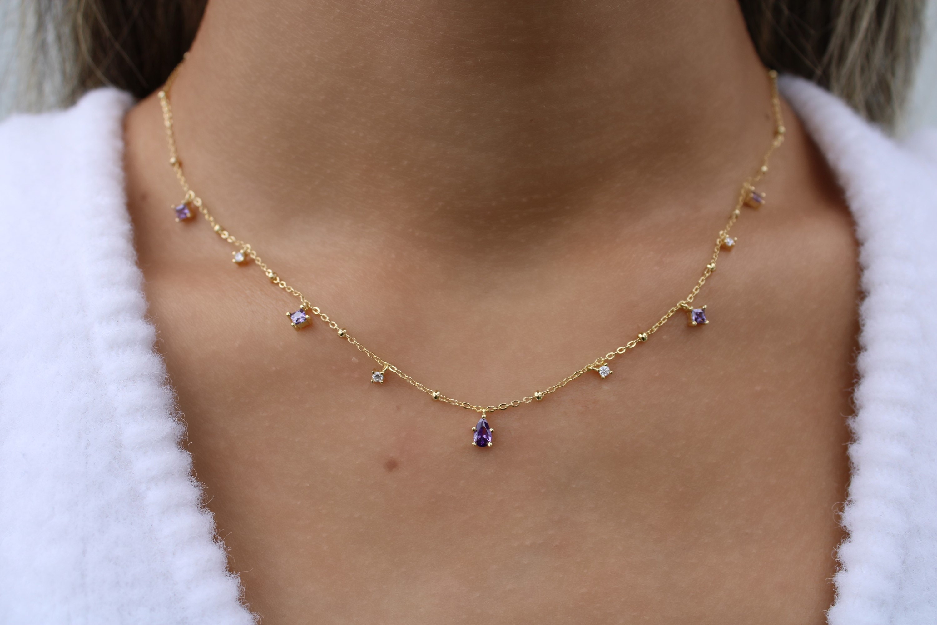 Gold necklace with purple best sale stone