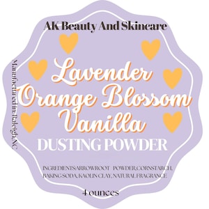 May include: A label for AK Beauty And Skincare dusting powder. The label is lavender with orange hearts and text. The text reads "Lavender Orange Blossom Vanilla DUSTING POWDER" and lists ingredients and 4 ounces.