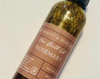 May include: A clear plastic bottle filled with oil and dried rosemary sprigs, featuring a black applicator cap. The brown label reads AK BEAUTY & SKINCARE, Hair Growth Oil, ROSEMARY, and NET WT: 4 oz, along with a list of ingredients and a small leaf icon.