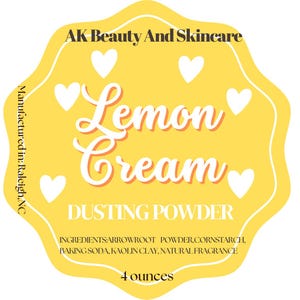 May include: A yellow label with white text that reads "Lemon Cream Dusting Powder." The label also includes the text "AK Beauty And Skincare" and "Manufactured in: Raleigh, NC." The label contains white hearts and lists ingredients and the amount of product, 4 ounces.