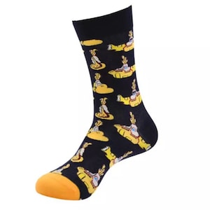May include: A pair of black socks with a yellow submarine pattern. The socks have a yellow toe and heel.