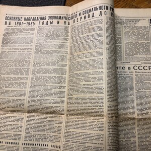 May include: A black and white newspaper page with the headline "Основные направления экономического и социального развития на 1981-1985 годы и на период до 19" in Cyrillic script. The article discusses economic and social development in the USSR.
