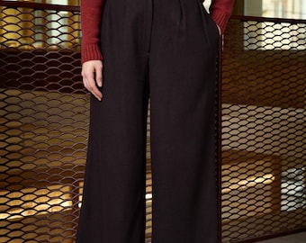 May include: A pair of wide-leg trousers in a dark brown color. The trousers have a high waist and a relaxed fit. The fabric appears to be a soft, woven material.