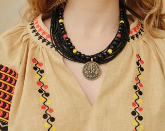 Ukrainian necklace. Black traditional necklace with brass flower pendant