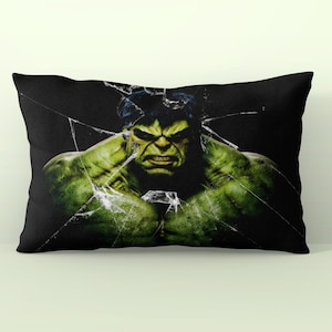 May include: A black pillow with a green Hulk graphic. The Hulk is shown with a cracked glass effect behind him.