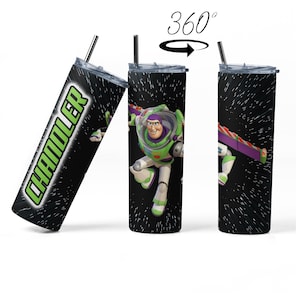 May include: A black and green stainless steel tumbler with a space-themed design featuring Buzz Lightyear from Toy Story. The tumbler has a straw and the name "Chandler" is written on the side.