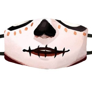 May include: A white face mask with a black and brown skull design. The mask has a stitched mouth and a black nose.