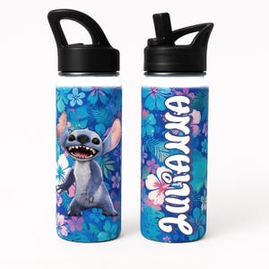 May include: Two stainless steel water bottles with black lids. One bottle features a blue cartoon character with large ears and a wide grin, set against a blue floral background. The other bottle has the name "Juliana" in white script.