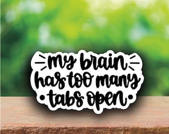 May include: White sticker with black text that reads "My brain has too many tabs open."