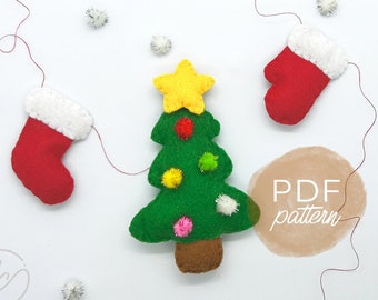 May include: A felt Christmas tree ornament with a yellow star on top and colorful pom-poms for decorations. Two red felt stocking ornaments are also included. The text "PDF pattern" is written on a brown circle in the background.