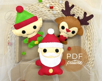 May include: Three felt Christmas ornaments: a red and white Santa Claus, a green elf, and a brown reindeer. The ornaments are on a woven basket with a white tulle fabric background. The text "PDF pattern" is visible in the lower right corner of the image.